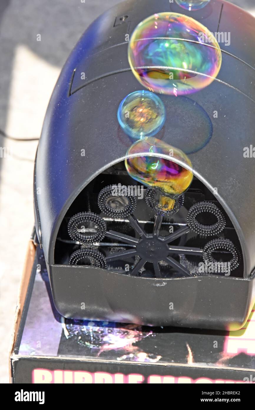 Soap bubble emerge from a bubble machine Stock Photo