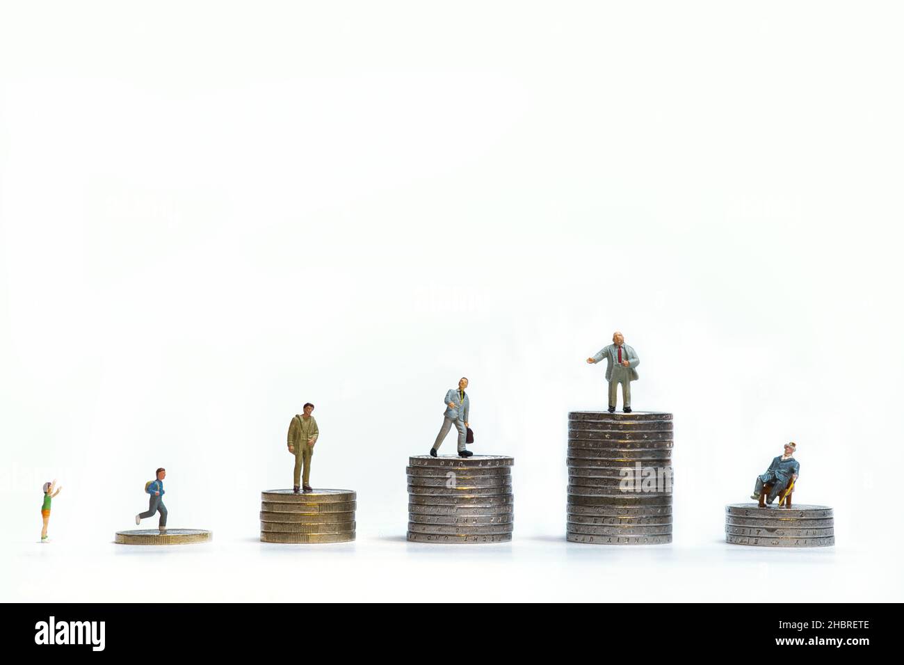 people on coin towers, concept: financial status from child to pensioner Stock Photo