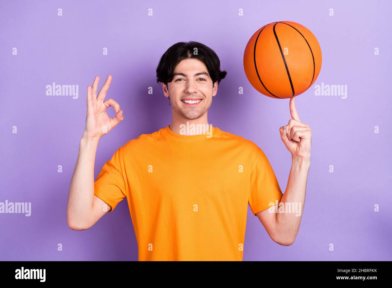 Photo Of Cheerful Young Positive Man Show Okay Sing Spin Basketball