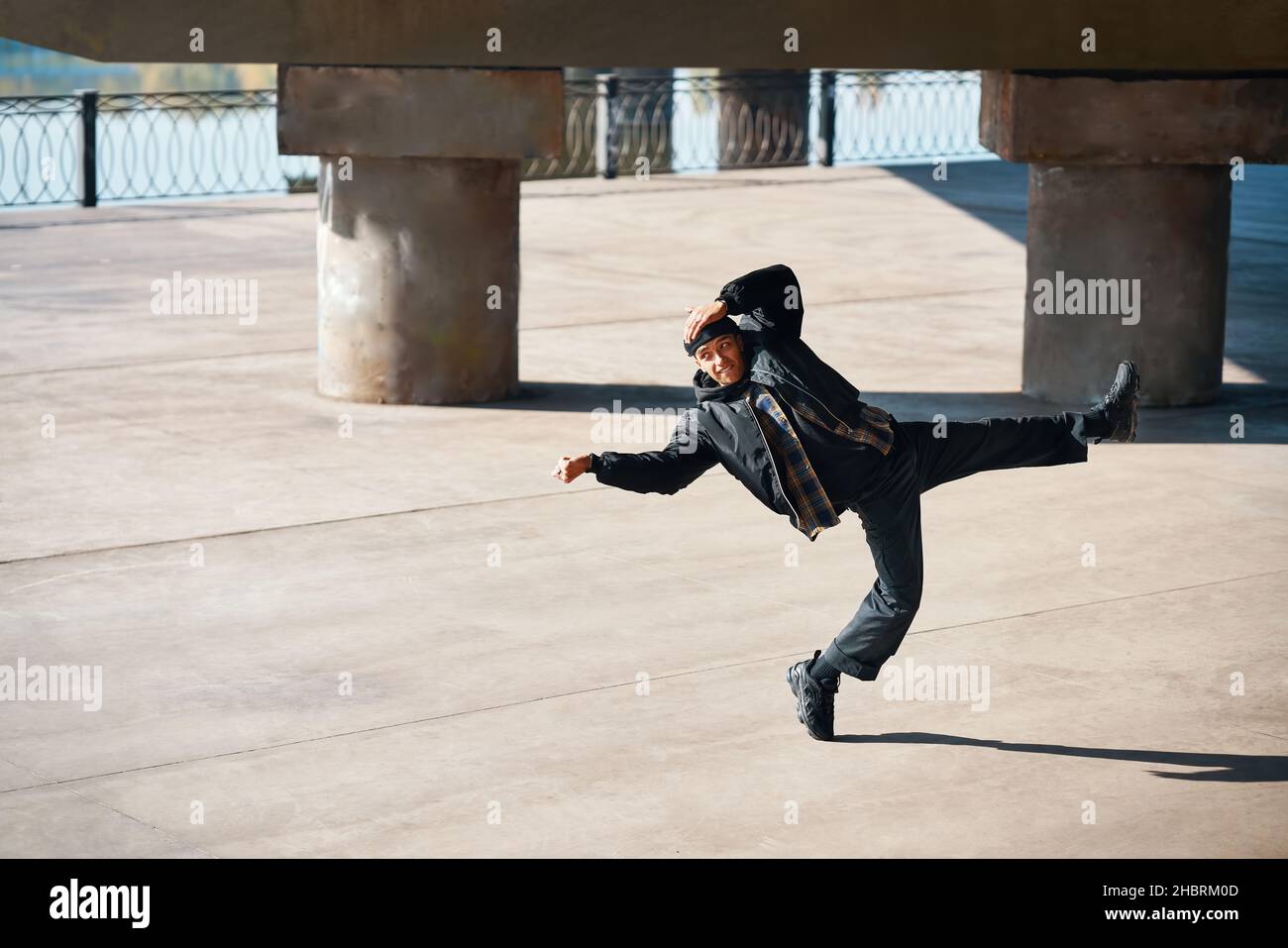 Stylish man dancing hip-hop on the street urban background. Youth culture, contemporary dance Stock Photo