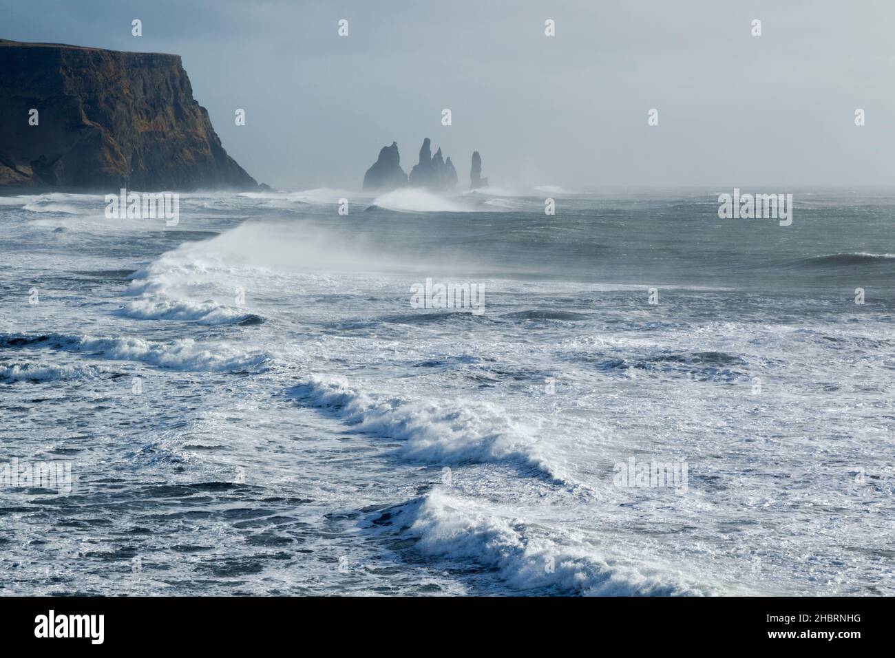 Rock stacks at Vik in a stormy sea with breaking waves and rocky ...