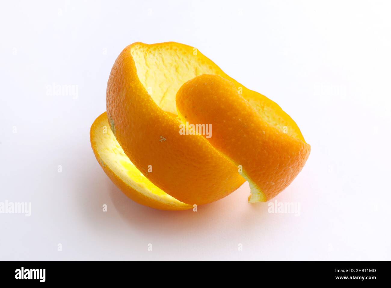 Orange peel on a white background. Spiral cut orange peel. Orange peel