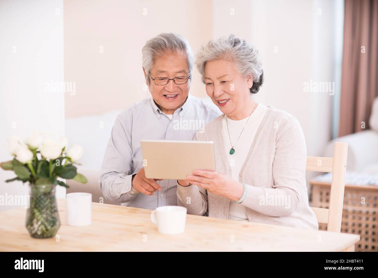 Elderly couple using a tablet computer at home Stock Photo