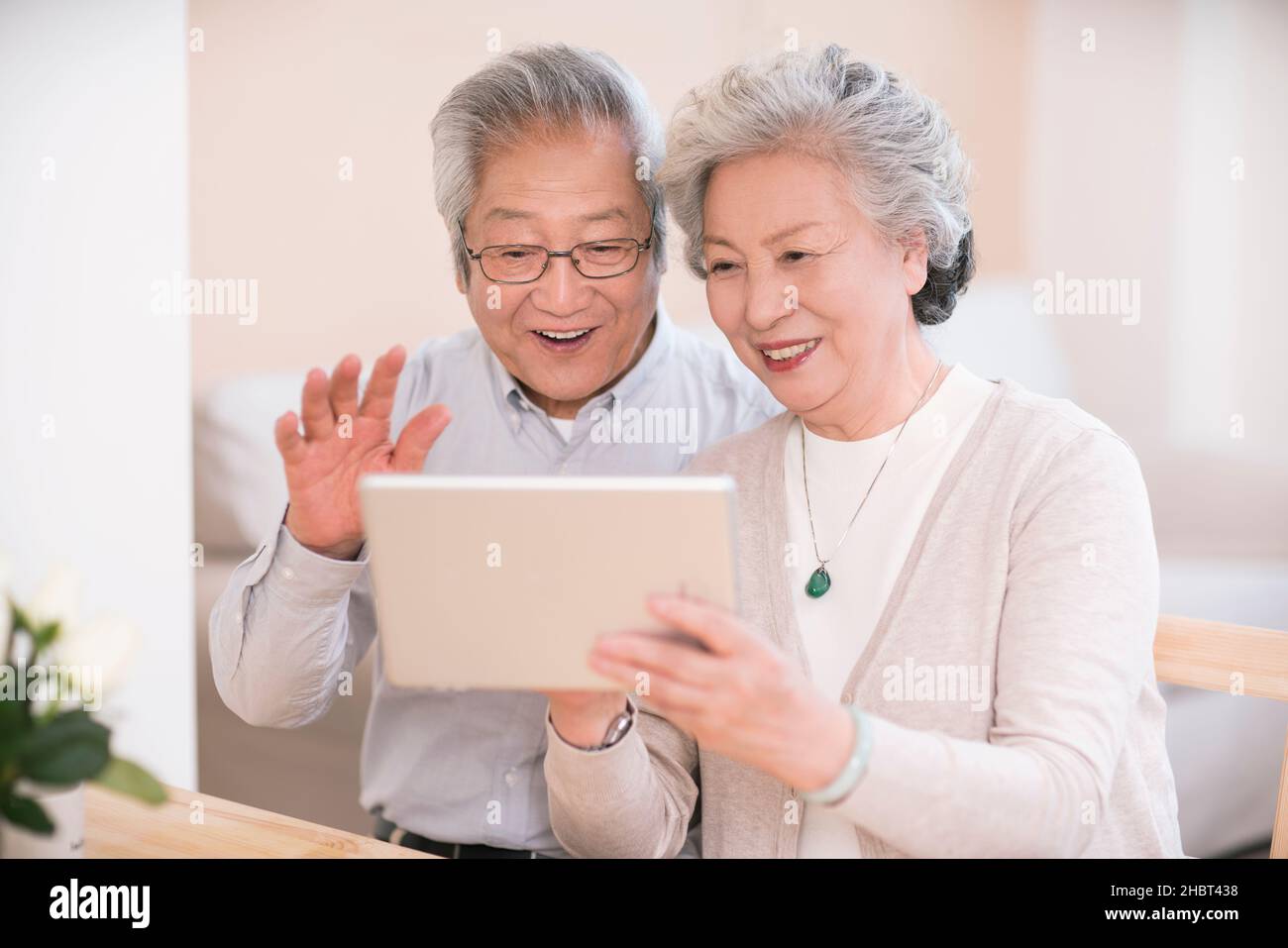 Elderly couple using a tablet computer at home Stock Photo
