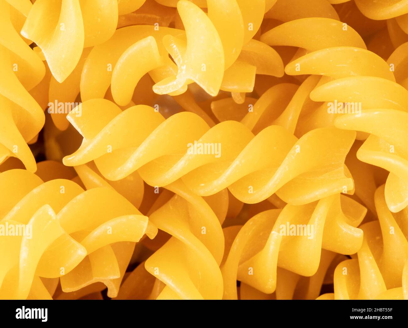 Macro food still life of Fusilli, fuˈzilli, pasta on plain background