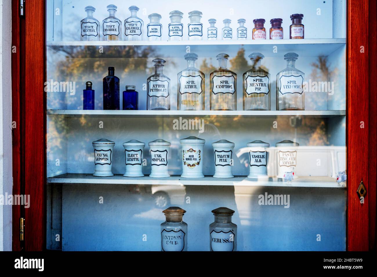 Old historical bottle and glass for different medicament in shop window of one of pharmacy, exhibition. Kourim, Czech republic. Stock Photo