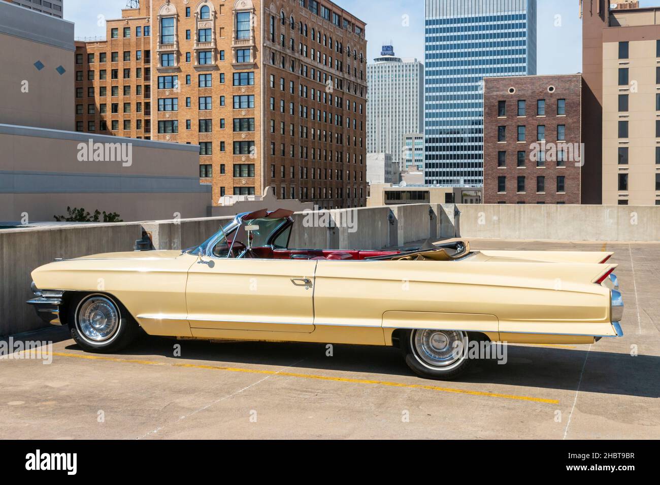 cream coloured 1962 vintage Cadillac coupe de ville parked on a car park roof Stock Photo
