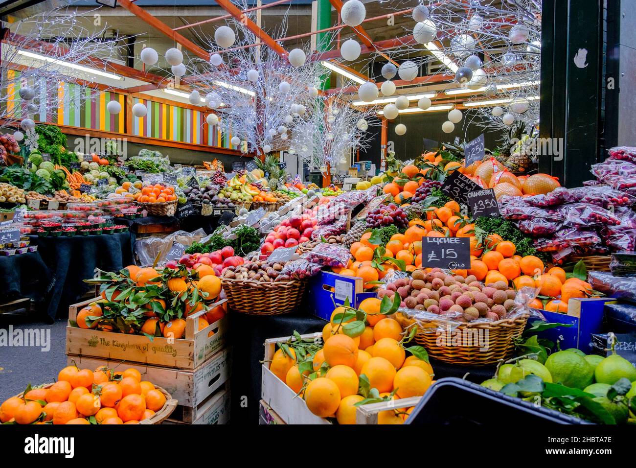 Colourful display of fresh fruit produce on stall at Borough Market during leadup to Christmas