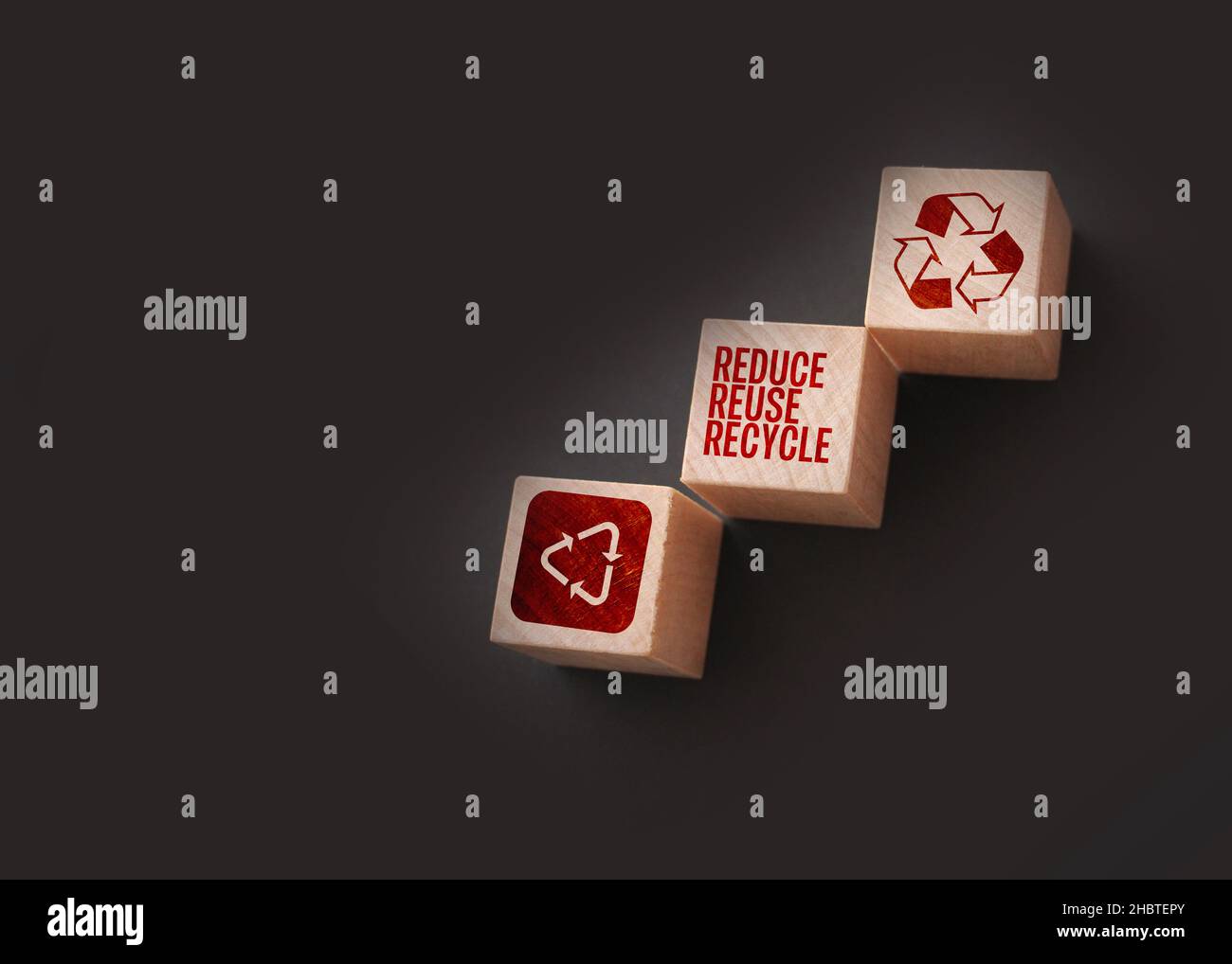 Reduce, reuse and recycle word written on wooden blocks on black. Save ...