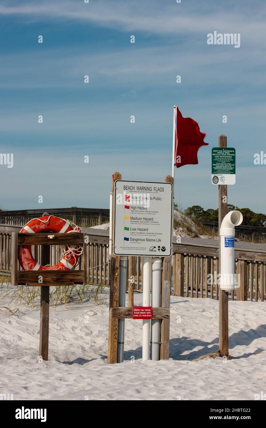 Red flag warnings posted along north Florida gulf beach, at Topsail Hill Preserve State Park, Florida, warning swimmers of existing conditions Stock Photo