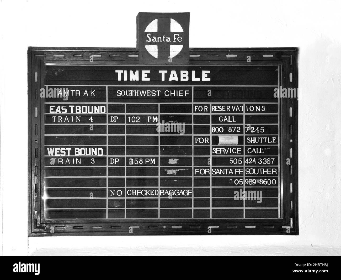 A time table in the Lamy, New Mexico, Amtrak train station shows the Southwest Chief train schedule for trains running between Los Angeles and Chicago Stock Photo