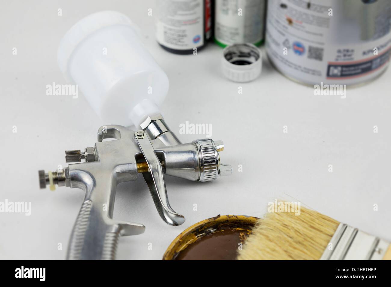 Instructions and a paint spray gun at work at the workplace in the