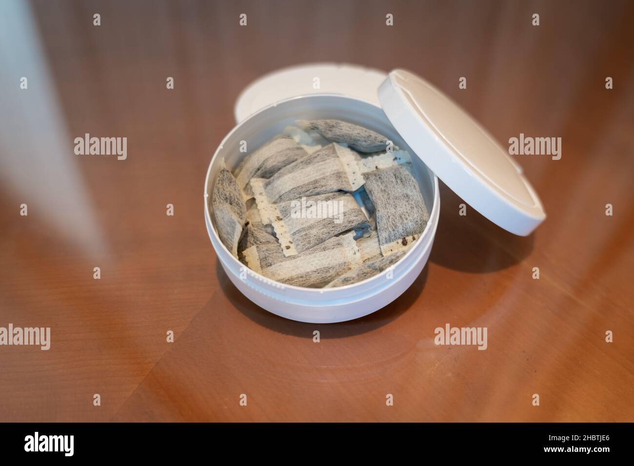 Snus, moist powder tobacco product widely consumed in Norway and Sweden and  among athletes, close-up with no label box Stock Photo