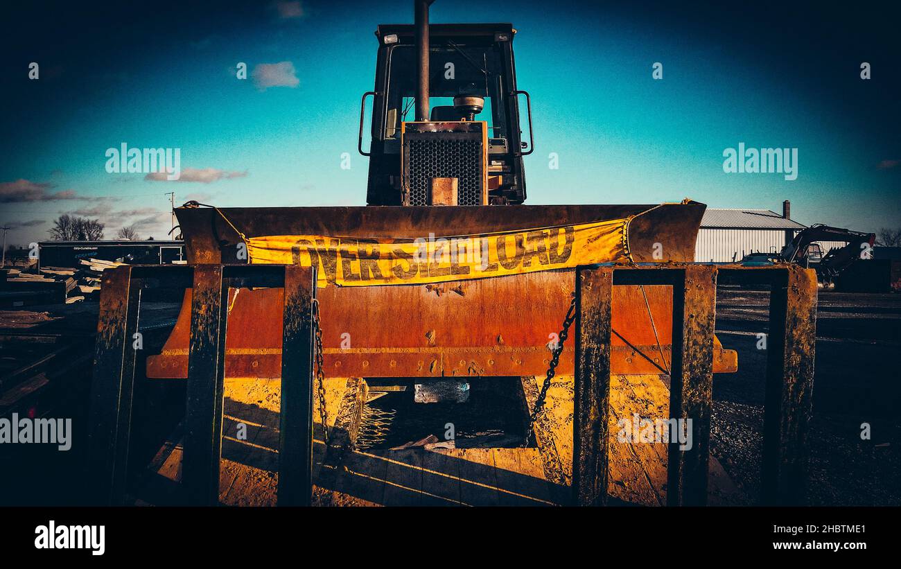Heavy machinery on trailers with rustic muddy looks Stock Photo