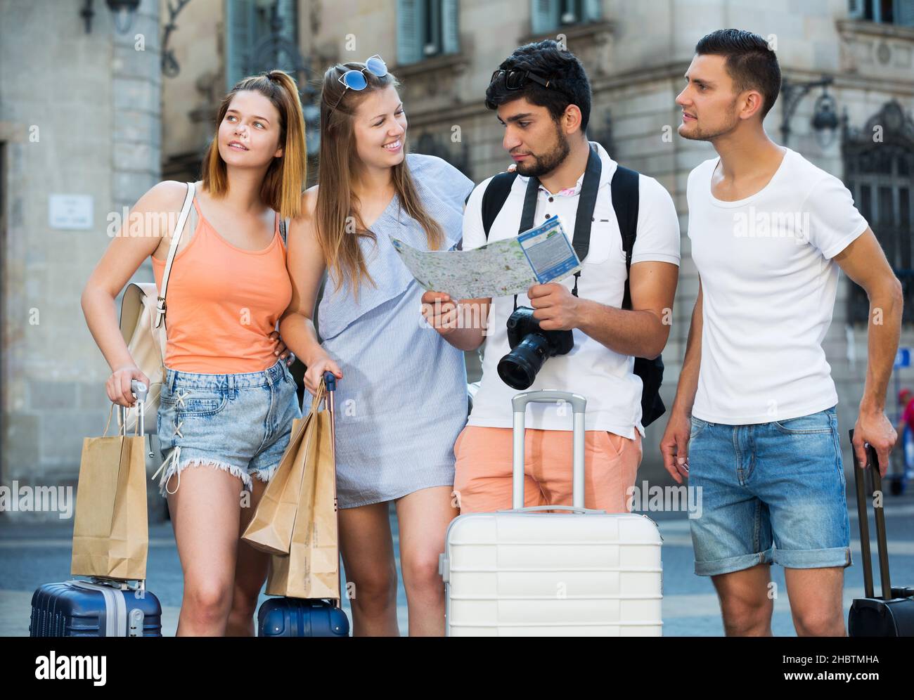 Travelers holding map and looking way Stock Photo