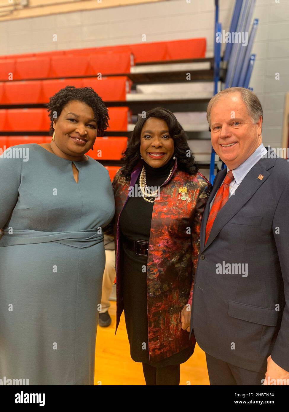 Stacey Abrams, Congresswoman Terri Sewell and Senator Doug Jones pose for a photo at a Unity