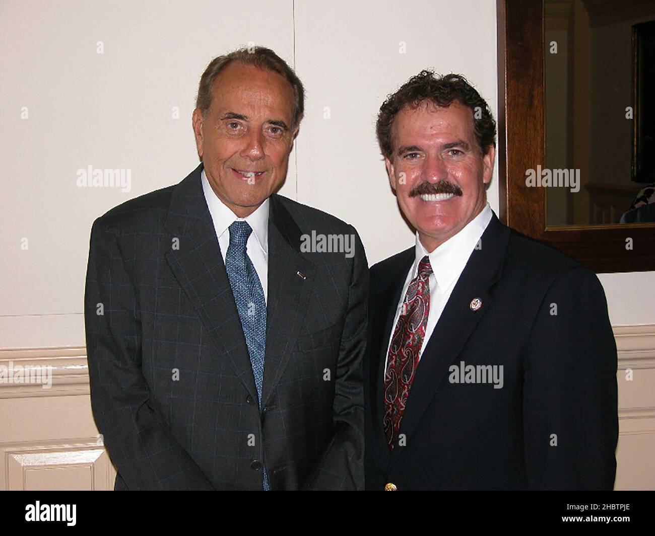 Phil Gingrey chats with former Senate Majority Leader Bob Dole (R-Kan.) after Dole addressed a group of House Republicans ca.  17 July 2003 Stock Photo