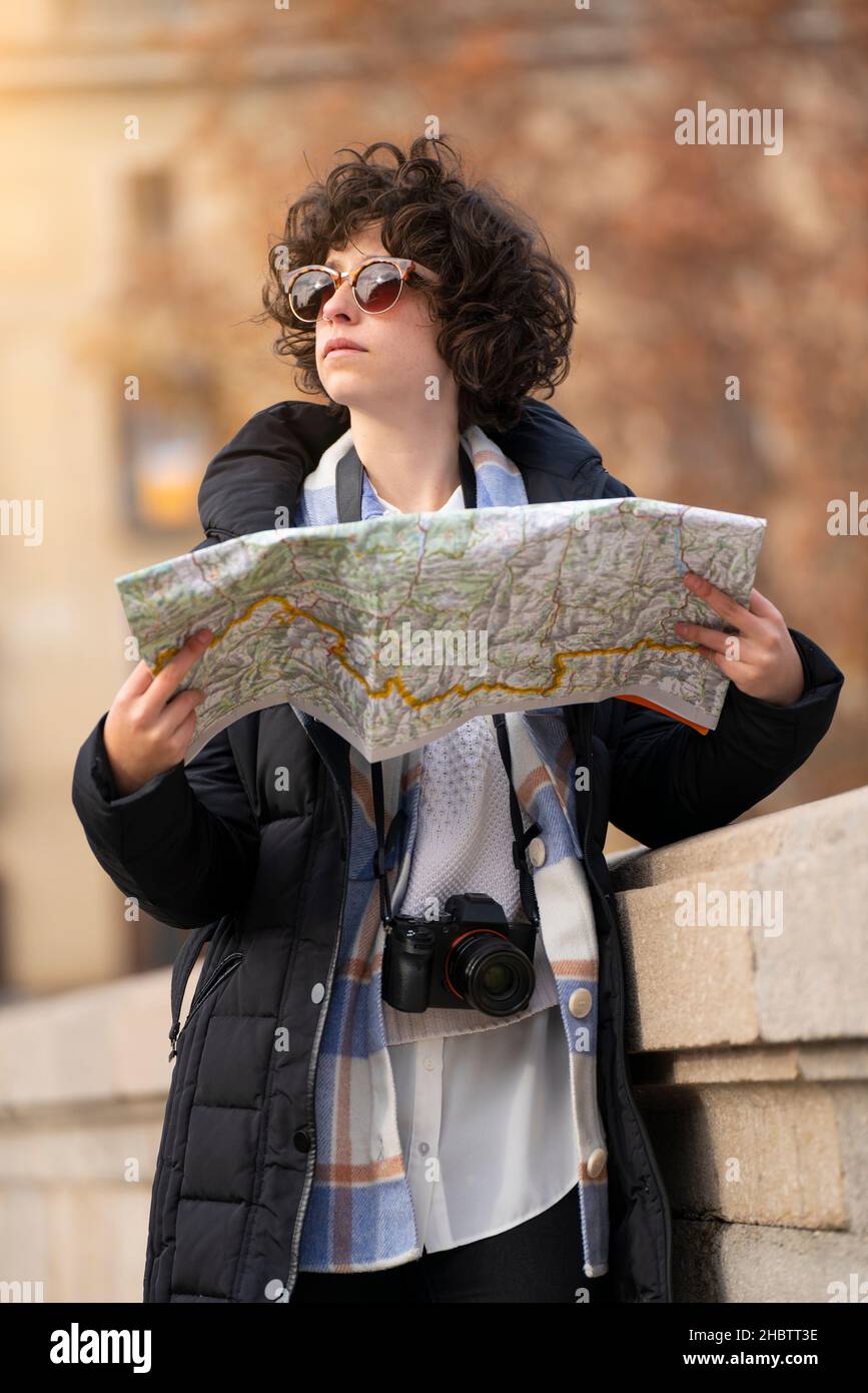 Young tourist woman searching in the city with a map Stock Photo