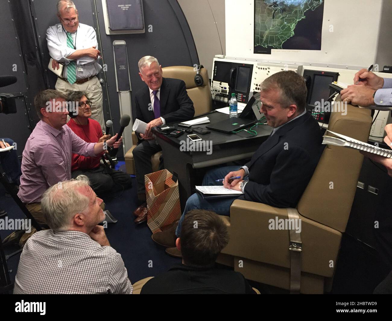 Secretary of Defense Jim Mattis and Dan Sullivan aboard a plane, talking to media  ca.  25 June 2018 Stock Photo