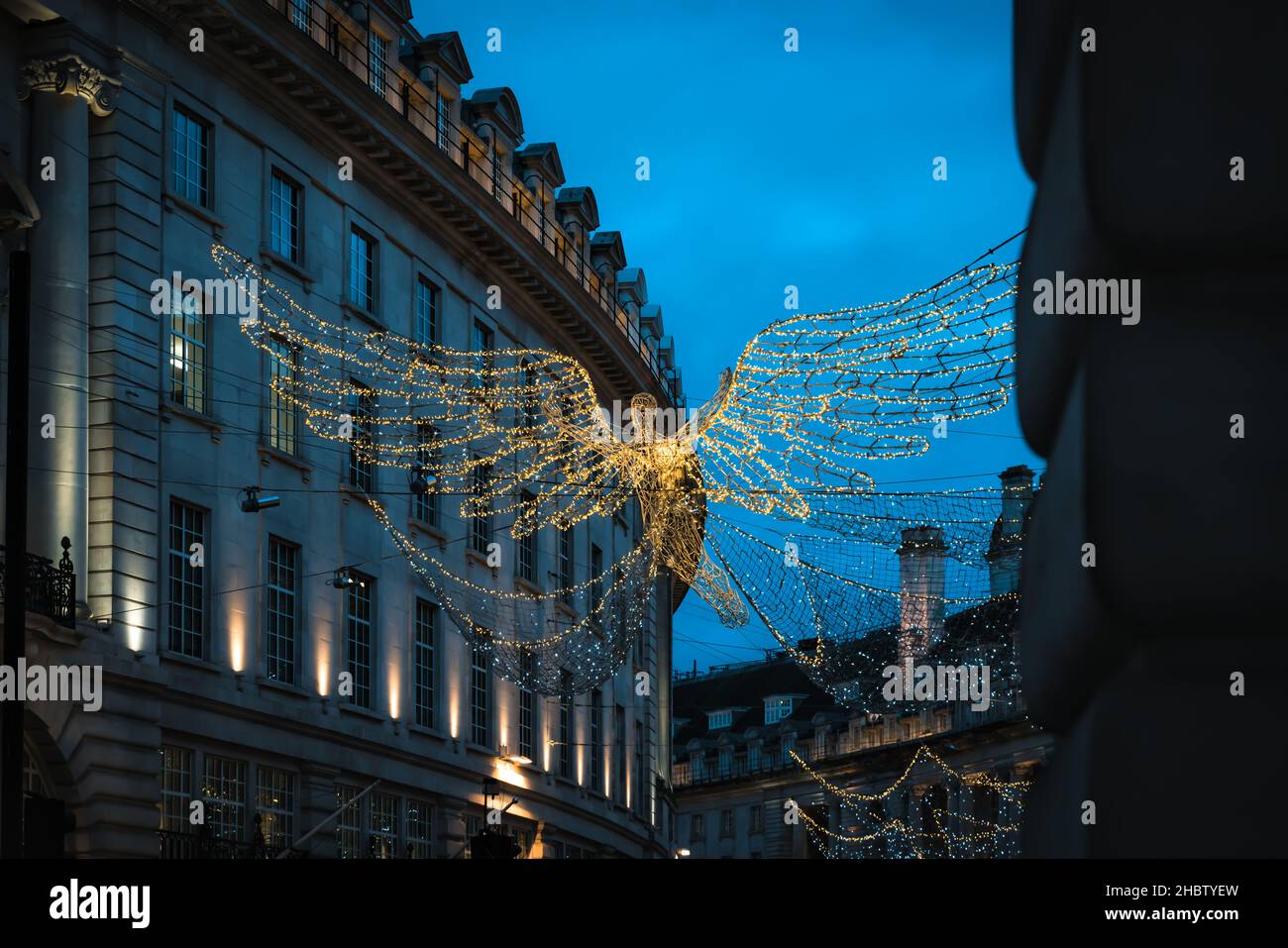 Christmas Angel Lights at Night in Festive Regent Street in Busy City of London, UK Stock Photo