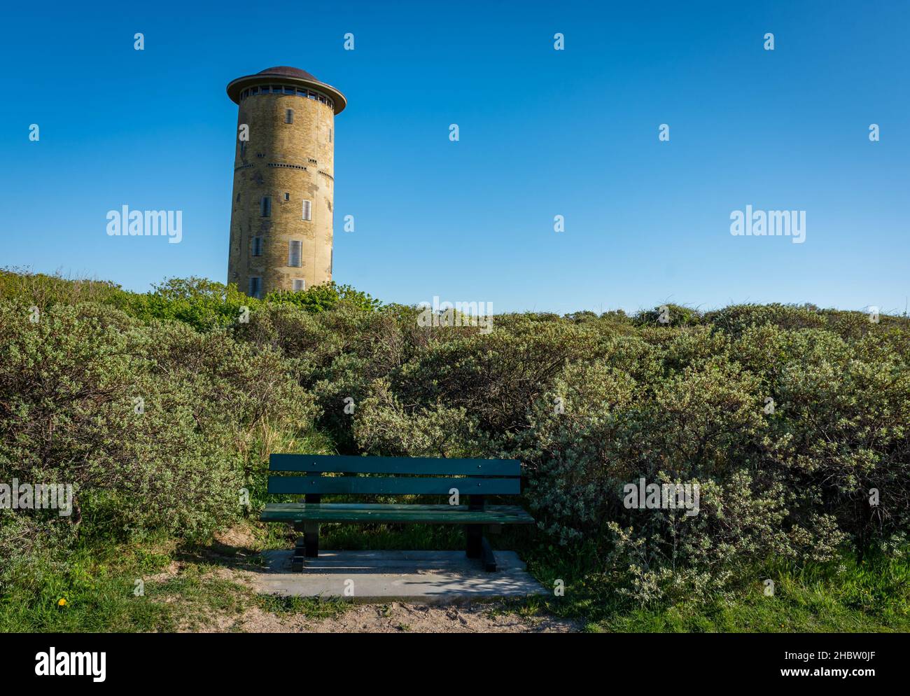 Water tower and public bench in Domburg, Province Zeeland, on a sunny summer day Stock Photo
