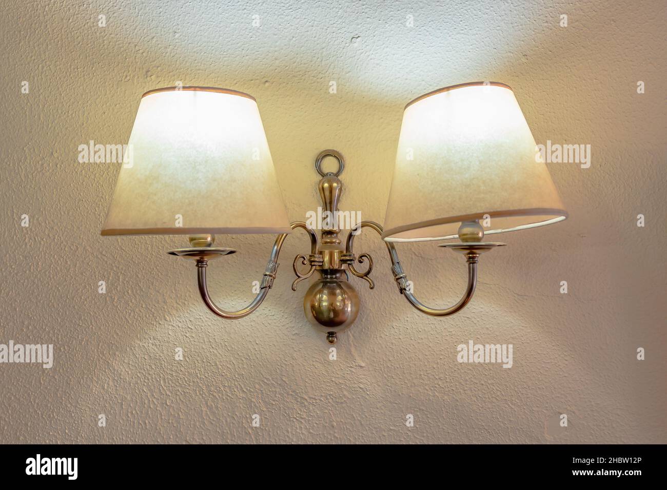 Antique pair of wall lamps over a white wall Stock Photo Alamy