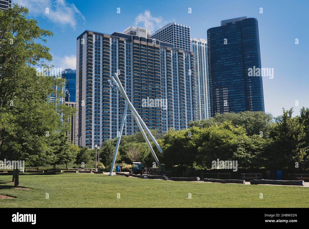 CHICAGO, UNITED STATES - Jun 13, 2021: A bright summer day in Millennium Park in Illinois with modern apartment buildings in the distance Stock Photo