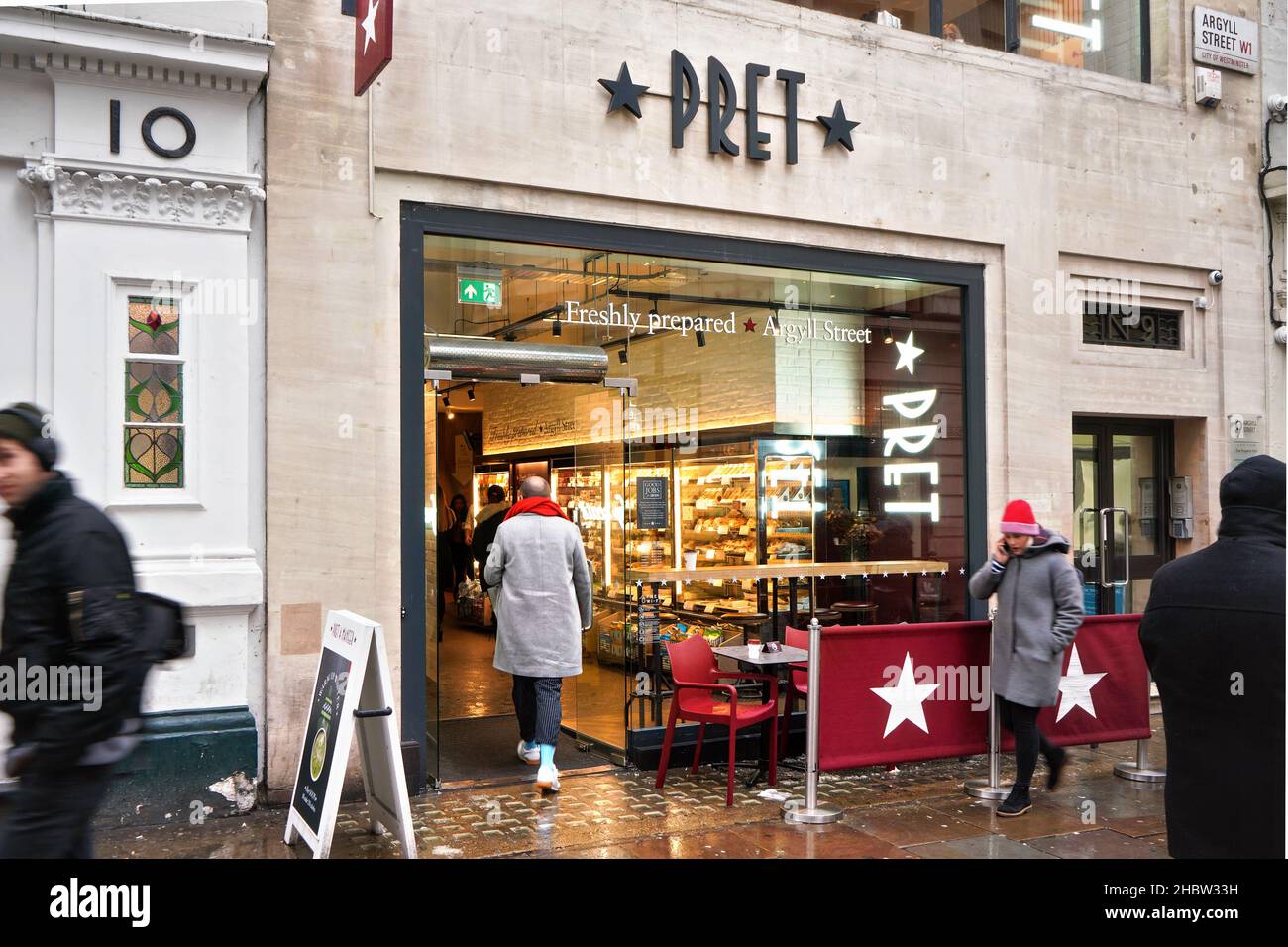 London, United Kingdom - February 01, 2019: Pedestrians walking in front Pret a Manger sandwich shop at one of their branch in central London on cold Stock Photo