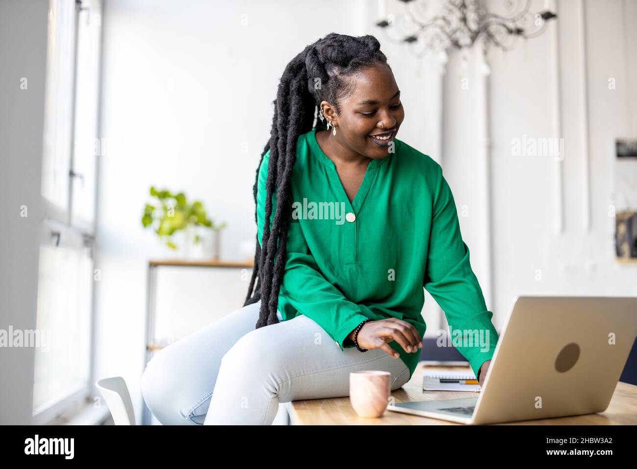 Woman working on laptop in her office Stock Photo
