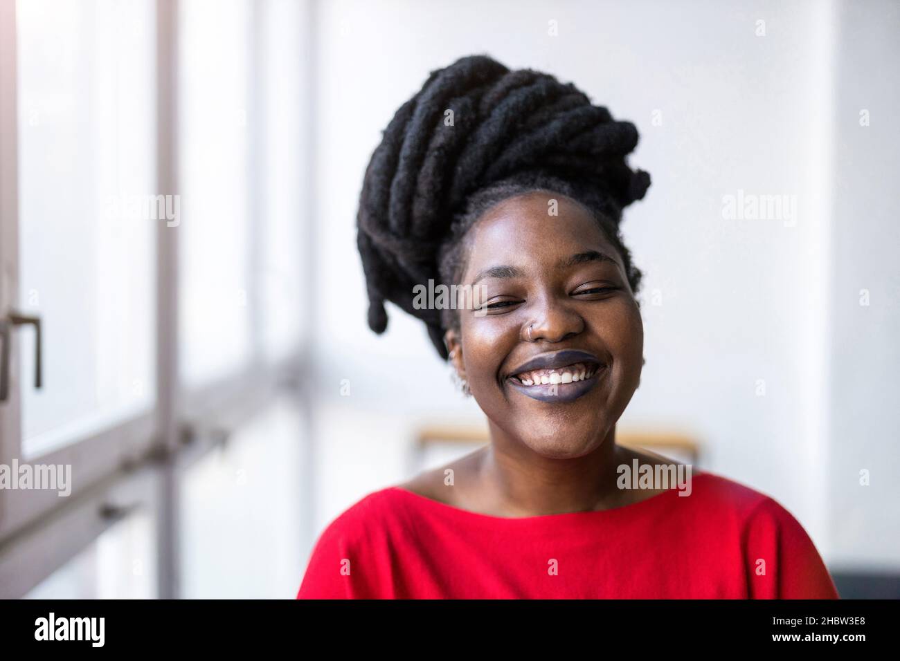 Portrait of a smiling young woman indoors Stock Photo
