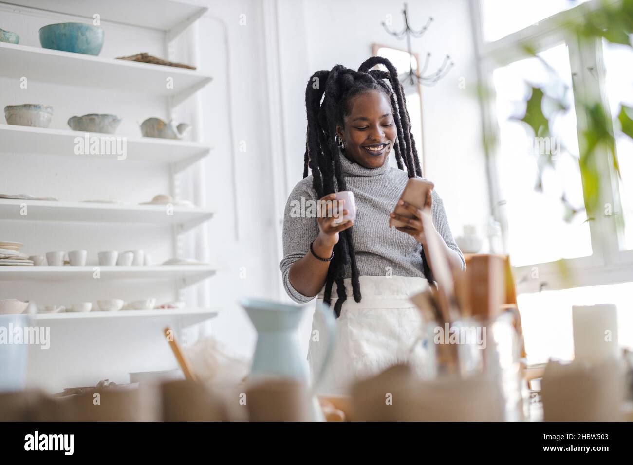Woman pottery artist working in her art studio Stock Photo - Alamy