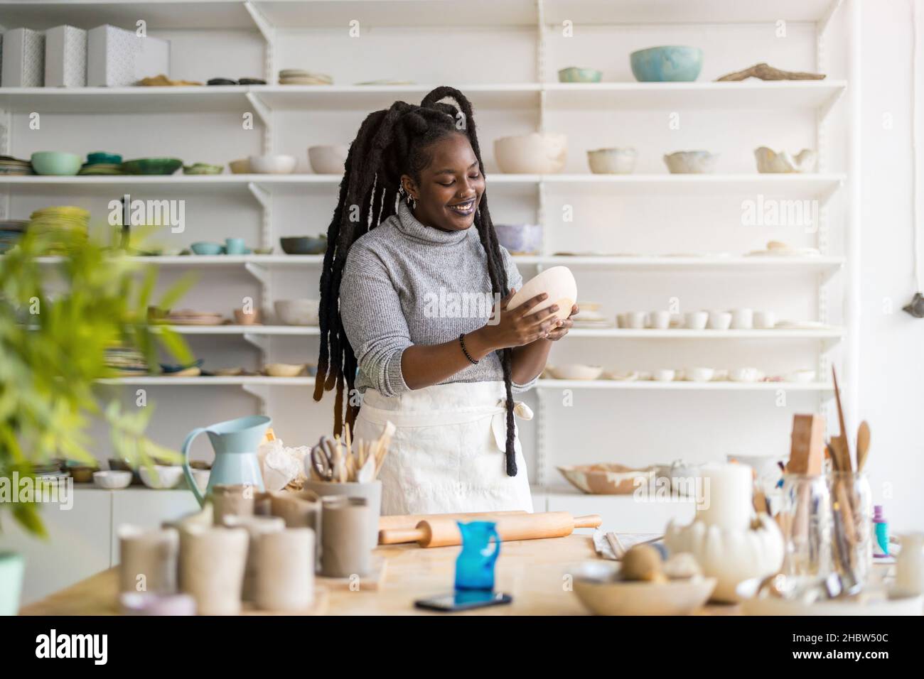 Woman pottery artist working in her art studio Stock Photo - Alamy