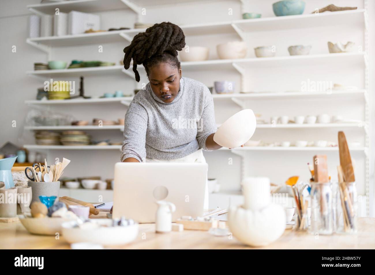 Woman pottery artist working in her art studio Stock Photo - Alamy