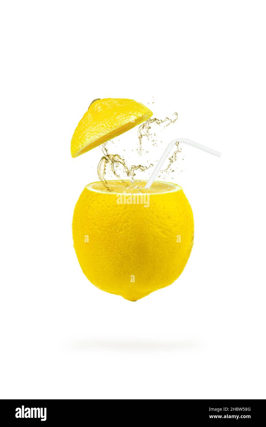 Summer refreshing drink cocktail. Levitation of lemon slices with a straw and splash on white background. Levitation of freshly cut lemon, vertical, c Stock Photo