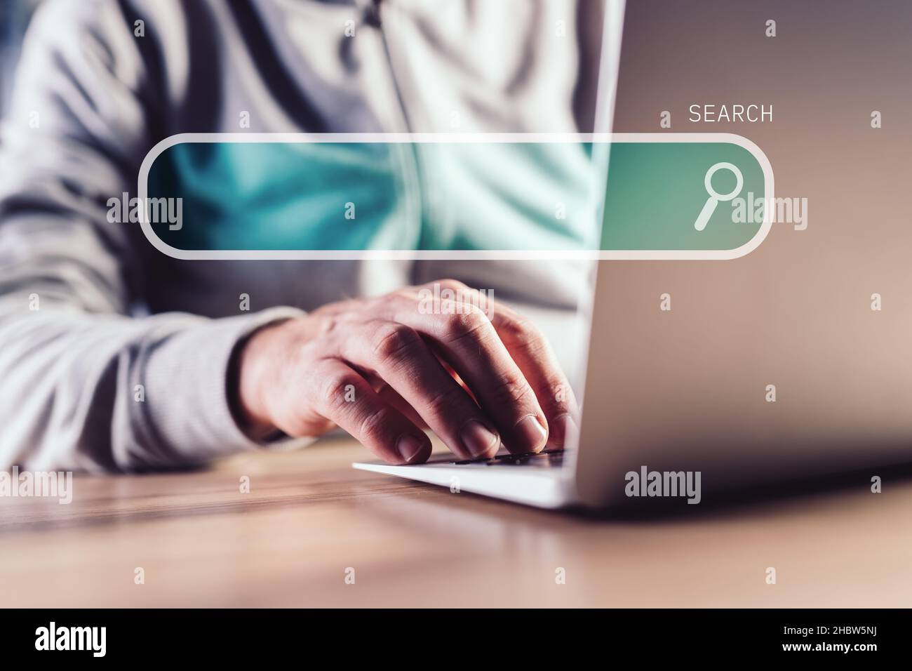 Internet search, casual man using laptop computer, selective focus Stock Photo