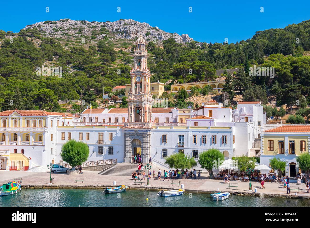 Tourists visiting in monastery of the Archangel Michael at Panormitis. Symi Island, Greece Stock Photo