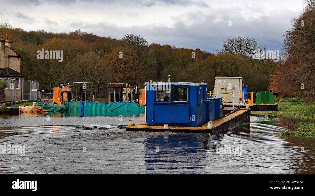 Canal work boat “Murillo” arrives at the winter works site at Dean Lock in the River Douglas valley on the Leeds and Liverpool canal in December 2021. Stock Photo