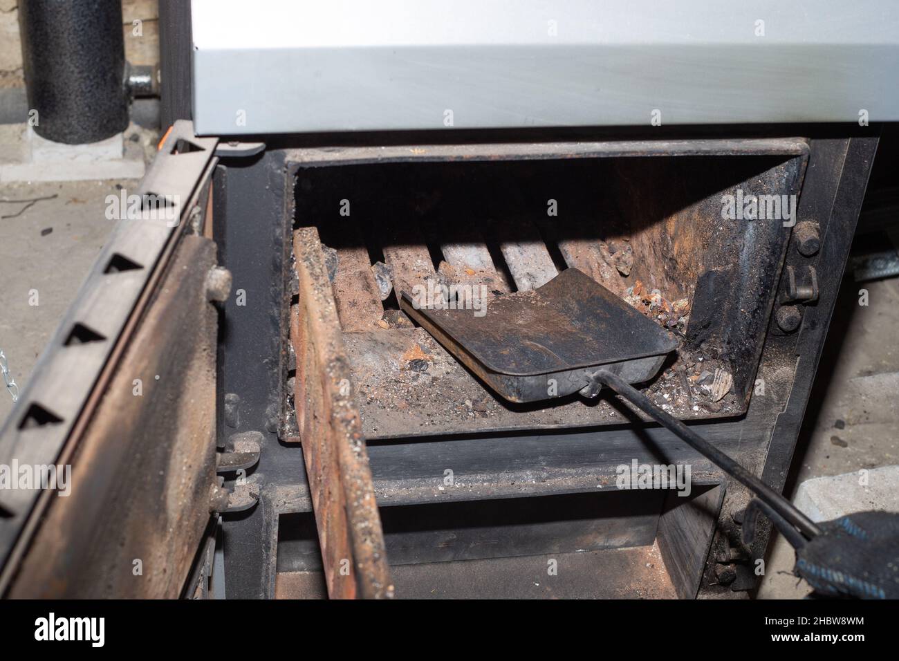 Cleaning the solid fuel boiler from the remains of firewood and coal