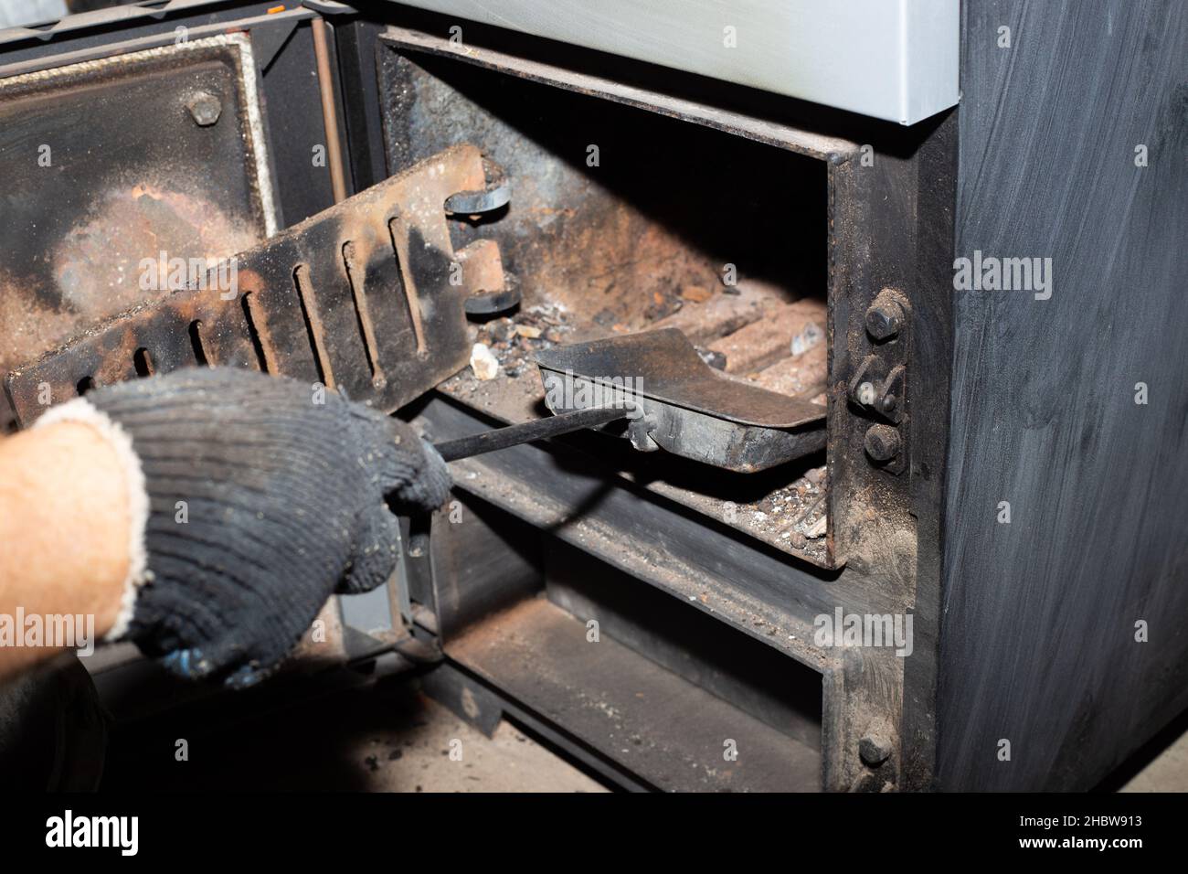 Cleaning the solid fuel boiler from the remains of firewood and coal