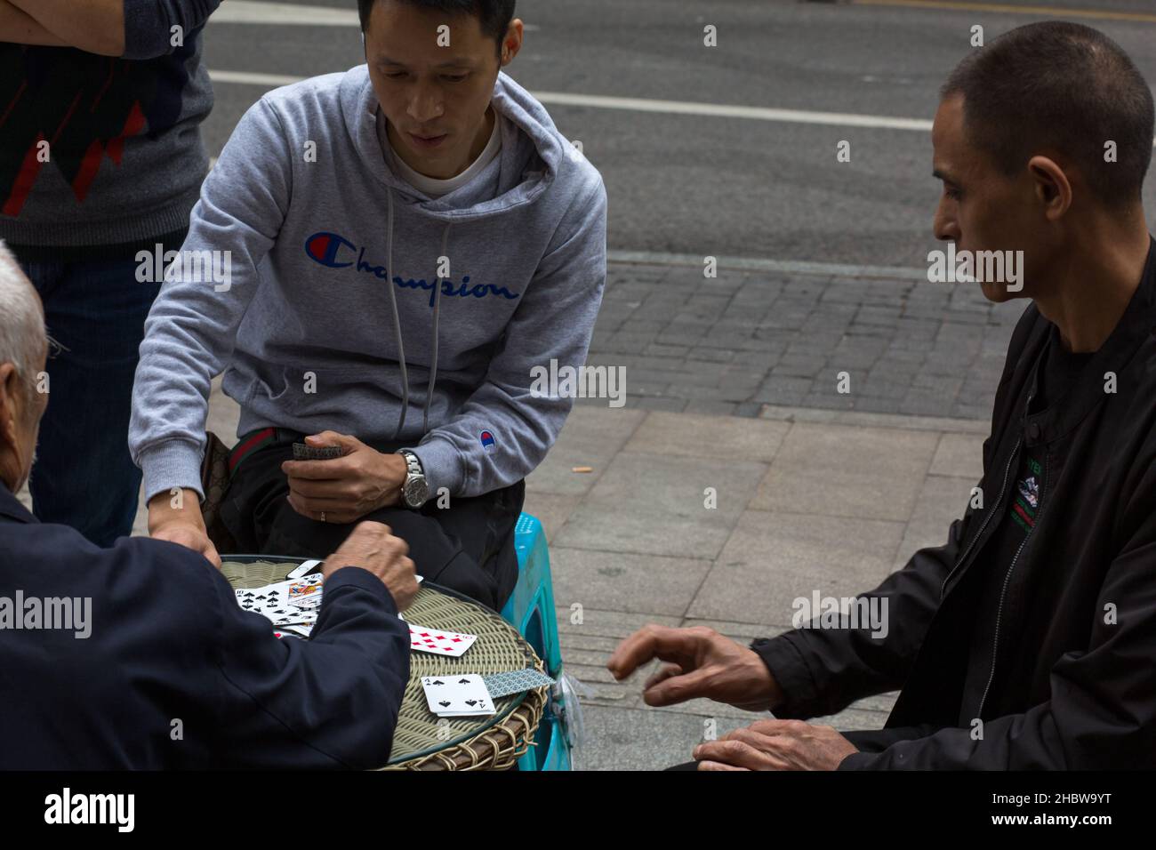 Tree men playing cards. Chongqing China Stock Photo
