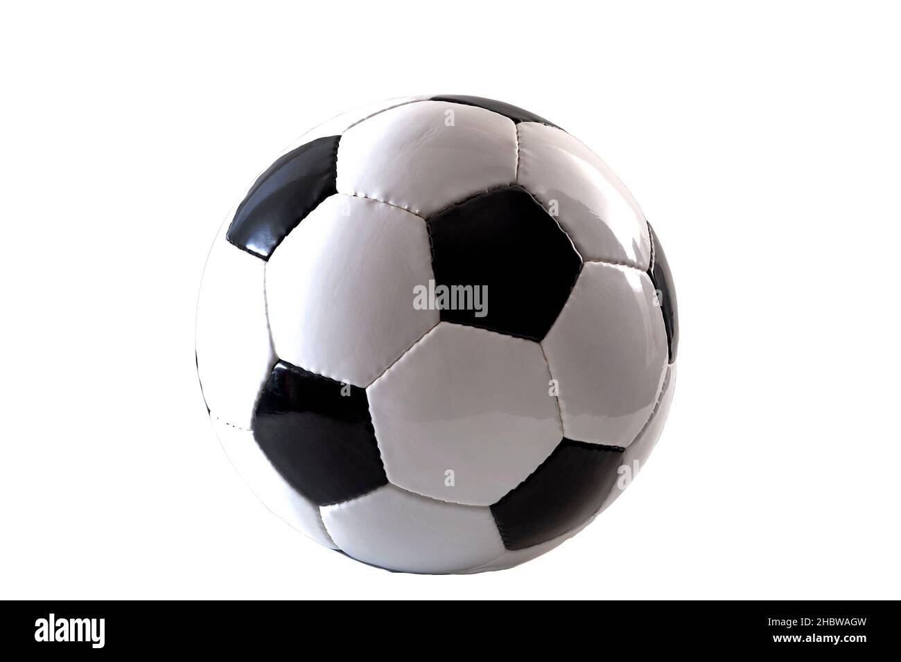 Sports equipment and leisure activity concept with a black and white generic classic leather football or soccer ball isolated on white background with Stock Photo