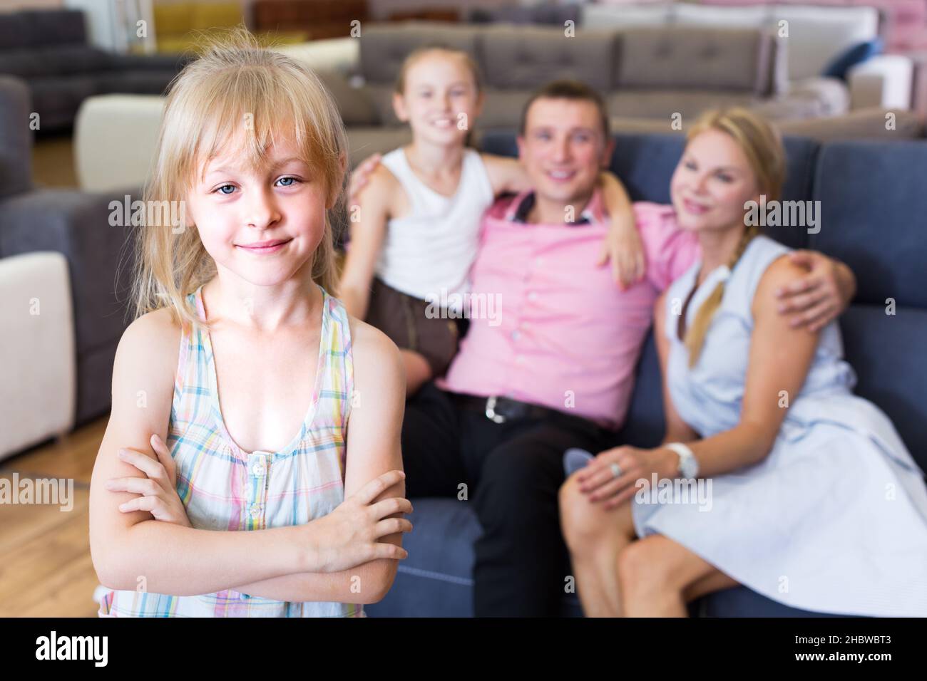 Young girl 8-12 years old is happyning of new sofa Stock Photo