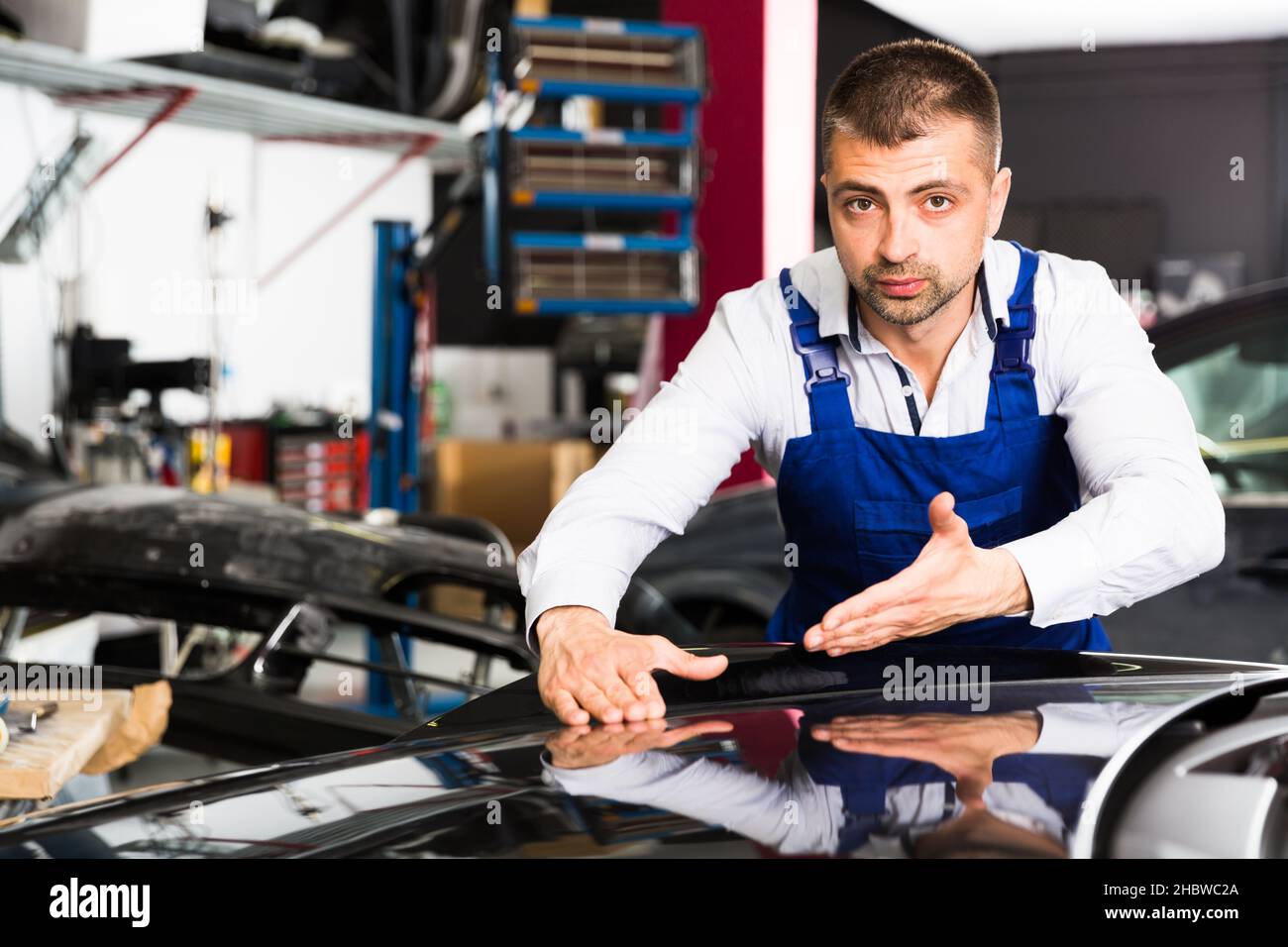 Car painter showing car after painting Stock Photo Alamy