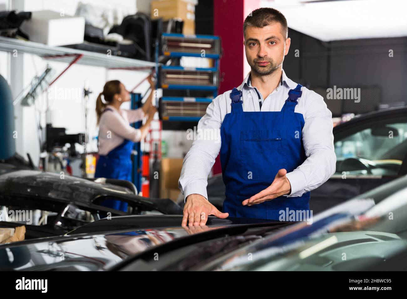 Car painter showing car after painting Stock Photo