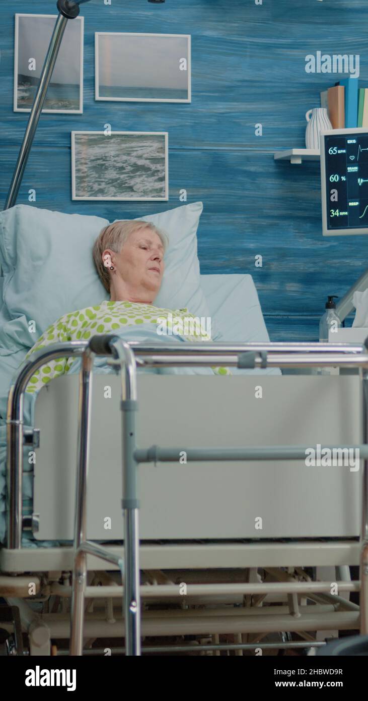 Medical team doing healthcare checkup for senior woman in hospital bed