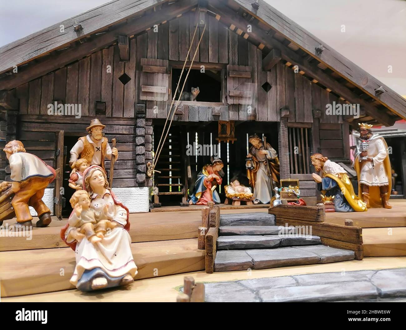 Traditional Christmas nativity scene with beautiful figures made out of wood. The birth of Jesus Christ in the manger surrounded by Joseph, Mary and t Stock Photo