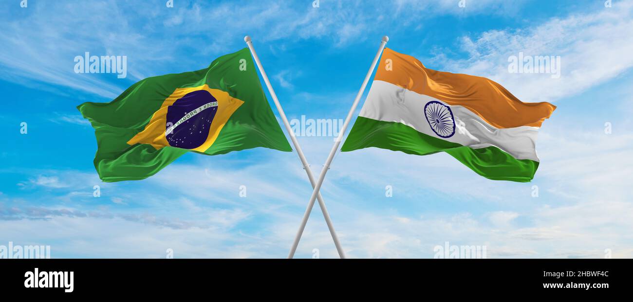 crossed national flags of Brazil and India flag waving in the wind at ...