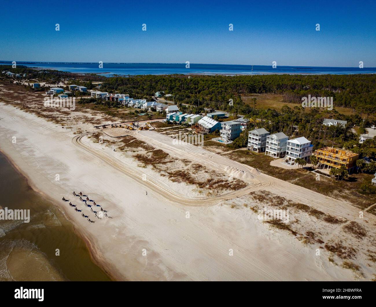An aerial view of beach houses surrounded by trees by the sea Stock ...