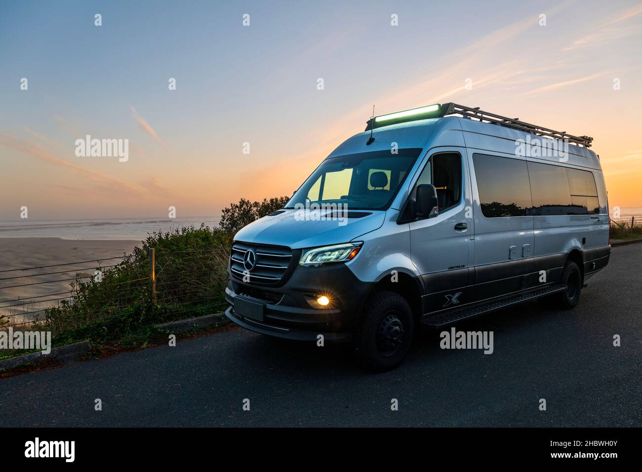 Airstream Interstate 24X 4WD; campervan; sunset over Pacific Ocean near Newport; Oregon; USA Stock Photo