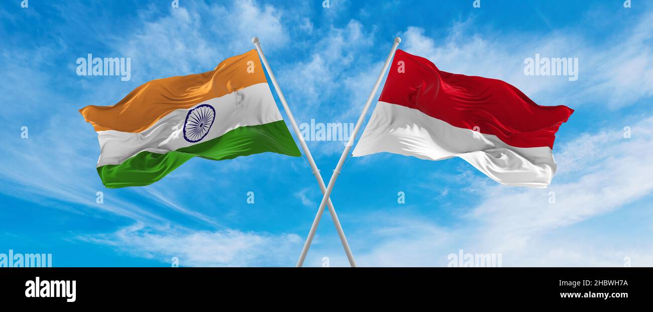 crossed national flags of India and Monaco flag waving in the wind at ...